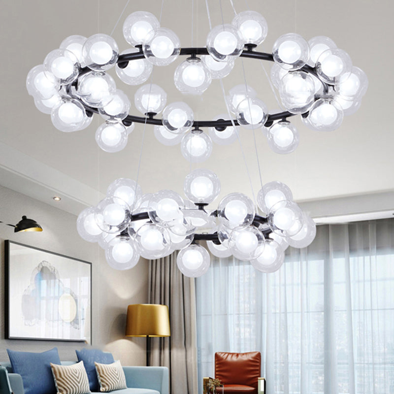 Bubble Chandelier Light Contemporary Clear Glass 2/3 Tiers Black Finish Hanging Lamp with Metal Ring for Living Room Black 2 Tiers Clearhalo 'Ceiling Lights' 'Chandeliers' 'Glass shade' 'Glass' 'Modern Chandeliers' 'Modern' Lighting' 113211