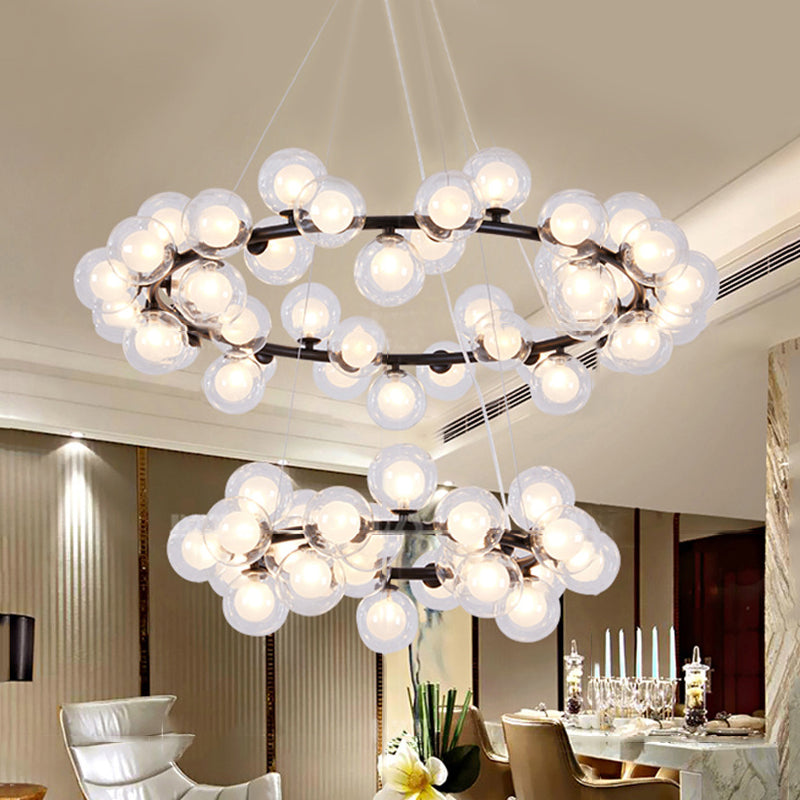 Bubble Chandelier Light Contemporary Clear Glass 2/3 Tiers Black Finish Hanging Lamp with Metal Ring for Living Room Clearhalo 'Ceiling Lights' 'Chandeliers' 'Glass shade' 'Glass' 'Modern Chandeliers' 'Modern' Lighting' 113212