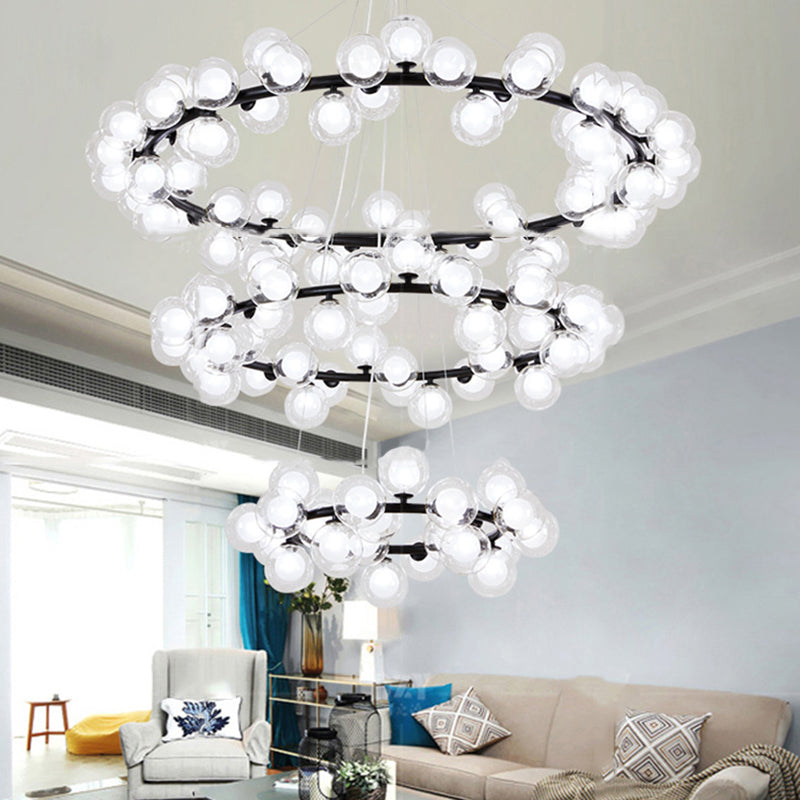 Bubble Chandelier Light Contemporary Clear Glass 2/3 Tiers Black Finish Hanging Lamp with Metal Ring for Living Room Black 3 Tiers Clearhalo 'Ceiling Lights' 'Chandeliers' 'Glass shade' 'Glass' 'Modern Chandeliers' 'Modern' Lighting' 113215