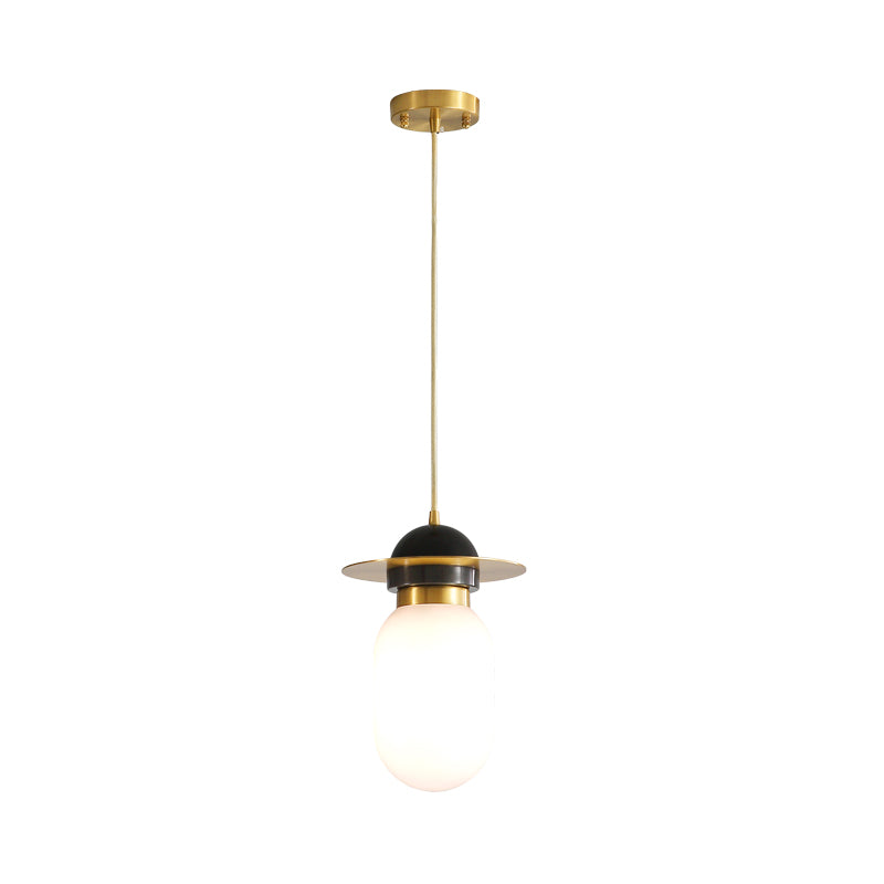 Pill Capsule Pendant Light Fixture Post-Modern White Glass Single Bedside Suspension Lamp in Brass Clearhalo 'Ceiling Lights' 'Glass shade' 'Glass' 'Modern Pendants' 'Modern' 'Pendant Lights' 'Pendants' Lighting' 1135724