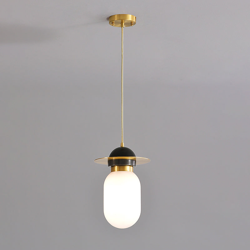 Pill Capsule Pendant Light Fixture Post-Modern White Glass Single Bedside Suspension Lamp in Brass Clearhalo 'Ceiling Lights' 'Glass shade' 'Glass' 'Modern Pendants' 'Modern' 'Pendant Lights' 'Pendants' Lighting' 1135725