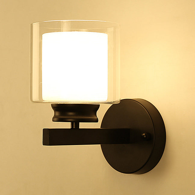 Cylinder Clear Glass Sconce Lighting Modern 1 Light Black/Chrome Wall Mounted Light Fixture Black Clearhalo 'Cast Iron' 'Glass' 'Industrial' 'Modern wall lights' 'Modern' 'Tiffany' 'Traditional wall lights' 'Wall Lamps & Sconces' 'Wall Lights' Lighting' 131679