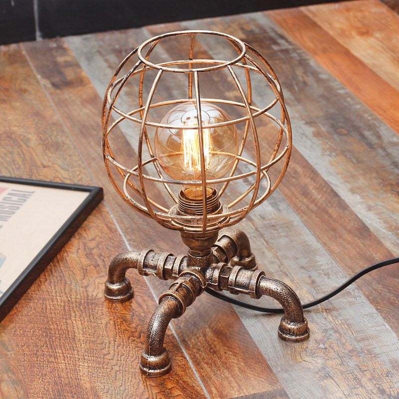 Metal Ball Cage Table Lamp with Pipe-Like Base Industrial Style 1 Bulb Bedroom Mini Table Light in Antique Bronze Clearhalo 'Lamps' 'Table Lamps' Lighting' 1417057