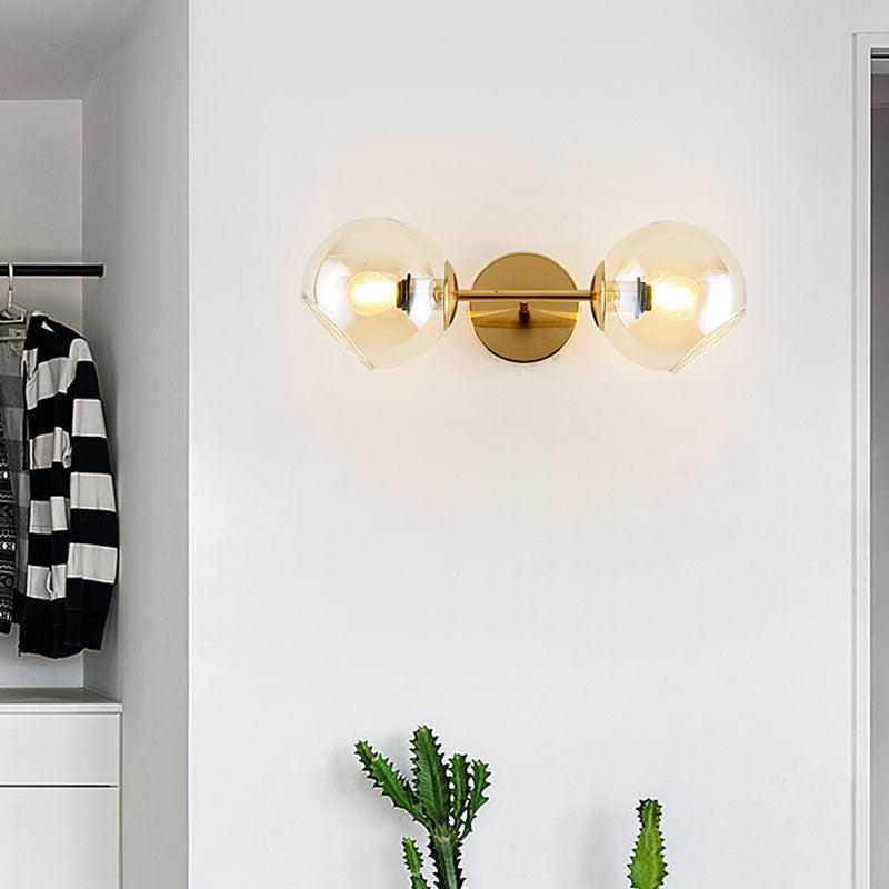 Modernist 2 Lights Wall Lamp with Clear Glass Shade Gold Spherical Wall Mount Light Fixture Clearhalo 'Cast Iron' 'Glass' 'Industrial' 'Modern wall lights' 'Modern' 'Tiffany' 'Traditional wall lights' 'Wall Lamps & Sconces' 'Wall Lights' Lighting' 144629