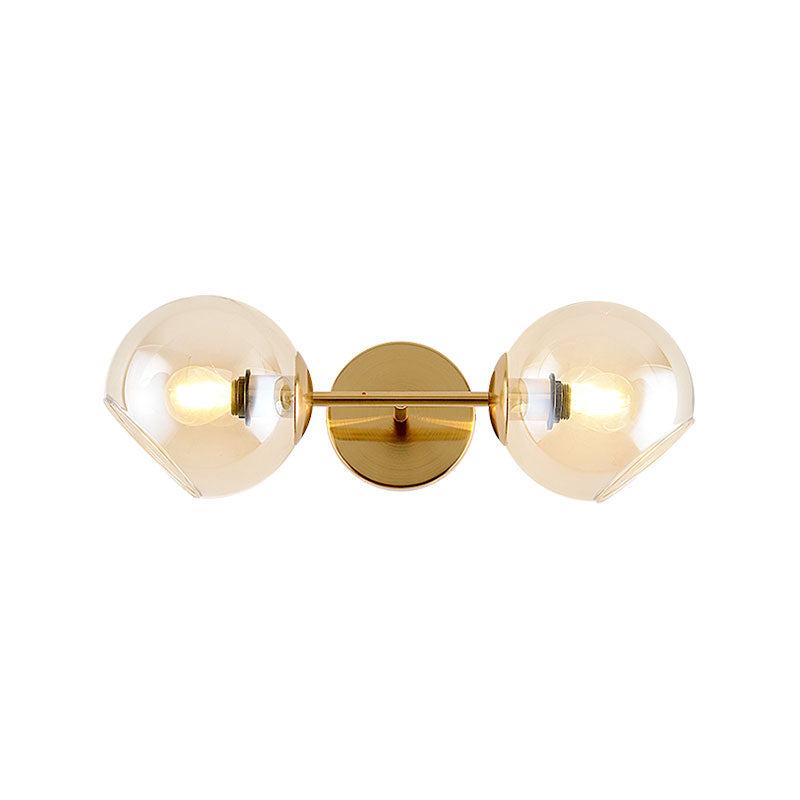 Modernist 2 Lights Wall Lamp with Clear Glass Shade Gold Spherical Wall Mount Light Fixture Clearhalo 'Cast Iron' 'Glass' 'Industrial' 'Modern wall lights' 'Modern' 'Tiffany' 'Traditional wall lights' 'Wall Lamps & Sconces' 'Wall Lights' Lighting' 144630