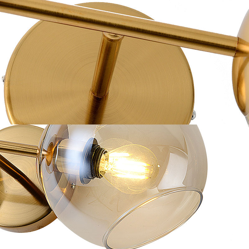 Modernist 2 Lights Wall Lamp with Clear Glass Shade Gold Spherical Wall Mount Light Fixture Clearhalo 'Cast Iron' 'Glass' 'Industrial' 'Modern wall lights' 'Modern' 'Tiffany' 'Traditional wall lights' 'Wall Lamps & Sconces' 'Wall Lights' Lighting' 144632