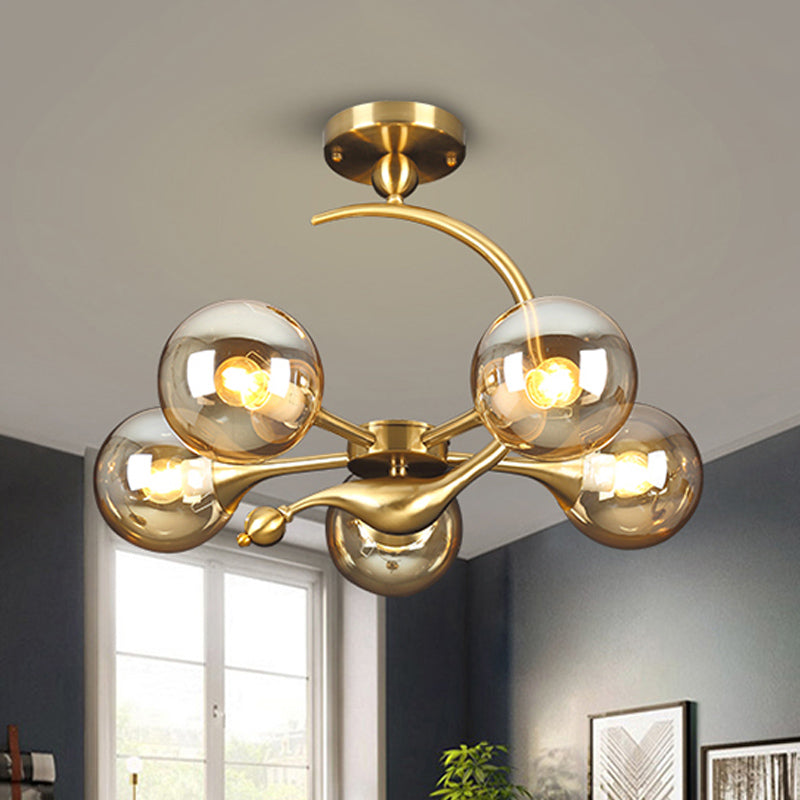 Burst Semi Flush Chandelier Postmodern Amber Glass Orb 3/5 Heads Brass Ceiling Mounted Light with Curved Arm over Table 5 Amber Clearhalo 'Ceiling Lights' 'Close To Ceiling Lights' 'Close to ceiling' 'Glass shade' 'Glass' 'Semi-flushmount' Lighting' 1454837