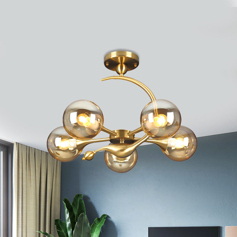 Burst Semi Flush Chandelier Postmodern Amber Glass Orb 3/5 Heads Brass Ceiling Mounted Light with Curved Arm over Table Clearhalo 'Ceiling Lights' 'Close To Ceiling Lights' 'Close to ceiling' 'Glass shade' 'Glass' 'Semi-flushmount' Lighting' 1454838