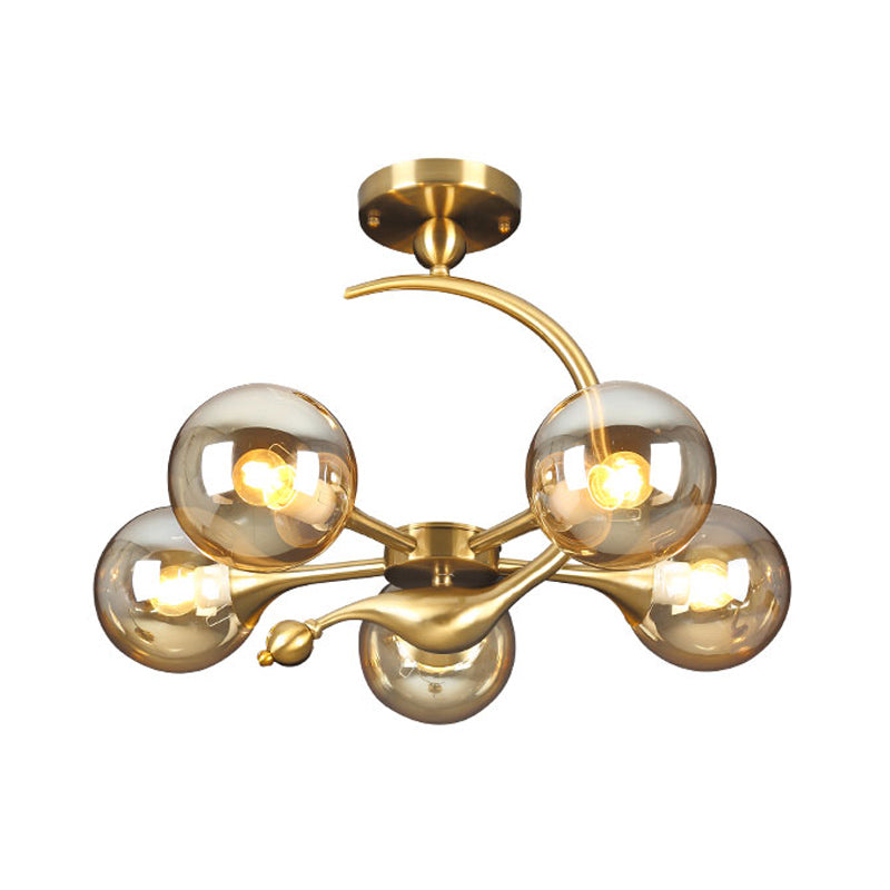 Burst Semi Flush Chandelier Postmodern Amber Glass Orb 3/5 Heads Brass Ceiling Mounted Light with Curved Arm over Table Clearhalo 'Ceiling Lights' 'Close To Ceiling Lights' 'Close to ceiling' 'Glass shade' 'Glass' 'Semi-flushmount' Lighting' 1454840