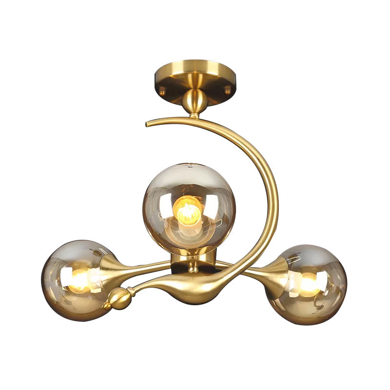 Burst Semi Flush Chandelier Postmodern Amber Glass Orb 3/5 Heads Brass Ceiling Mounted Light with Curved Arm over Table Clearhalo 'Ceiling Lights' 'Close To Ceiling Lights' 'Close to ceiling' 'Glass shade' 'Glass' 'Semi-flushmount' Lighting' 1454845