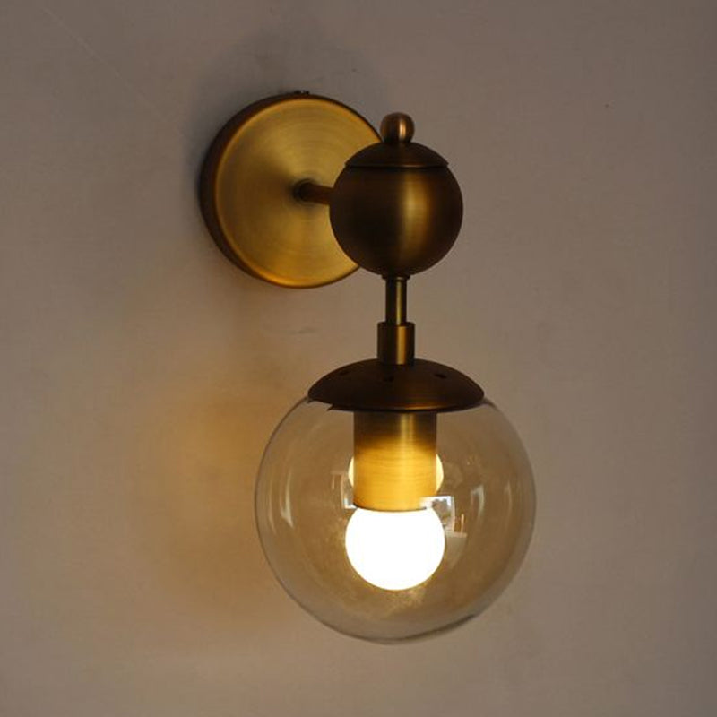 Globe Shaped Wall Sconce Post Modern Amber Glass 1/2 Light Brass Wall Mount Lighting Clearhalo 'Cast Iron' 'Glass' 'Industrial' 'Modern wall lights' 'Modern' 'Tiffany' 'Traditional wall lights' 'Wall Lamps & Sconces' 'Wall Lights' Lighting' 1523323