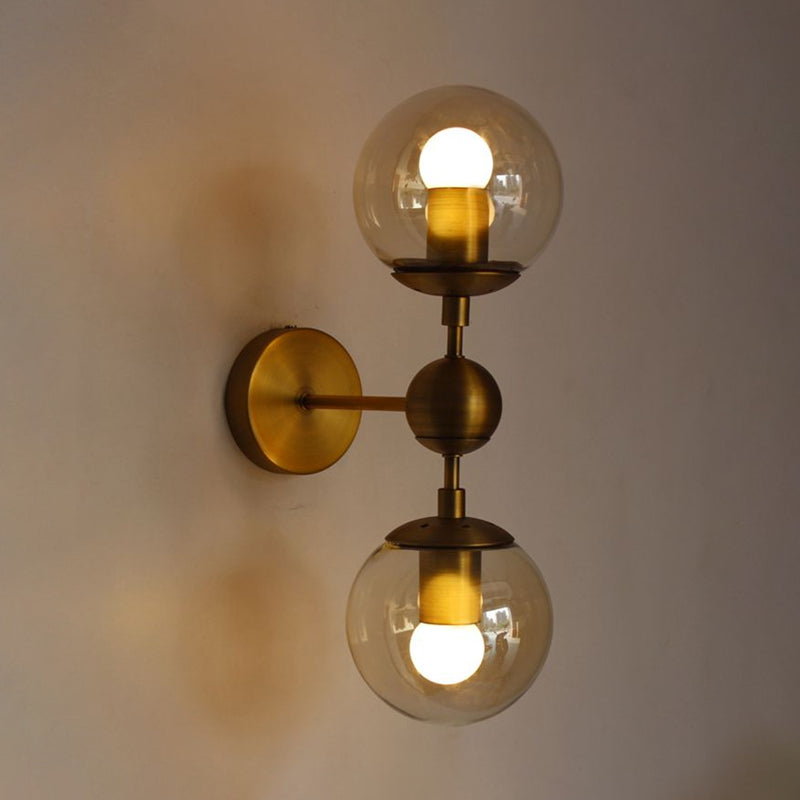 Globe Shaped Wall Sconce Post Modern Amber Glass 1/2 Light Brass Wall Mount Lighting Clearhalo 'Cast Iron' 'Glass' 'Industrial' 'Modern wall lights' 'Modern' 'Tiffany' 'Traditional wall lights' 'Wall Lamps & Sconces' 'Wall Lights' Lighting' 1523324
