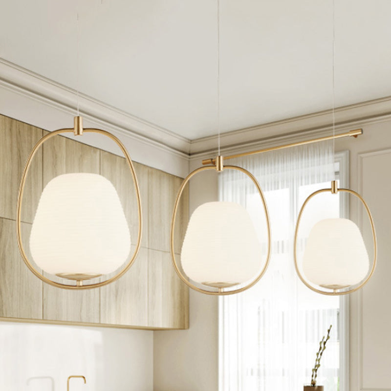 Oval Dining Room Pendant White Glass 1 Light Modern Hanging Lamp Fixture in Gold with Iron Ring Clearhalo 'Ceiling Lights' 'Glass shade' 'Glass' 'Modern Pendants' 'Modern' 'Pendant Lights' 'Pendants' Lighting' 1523435