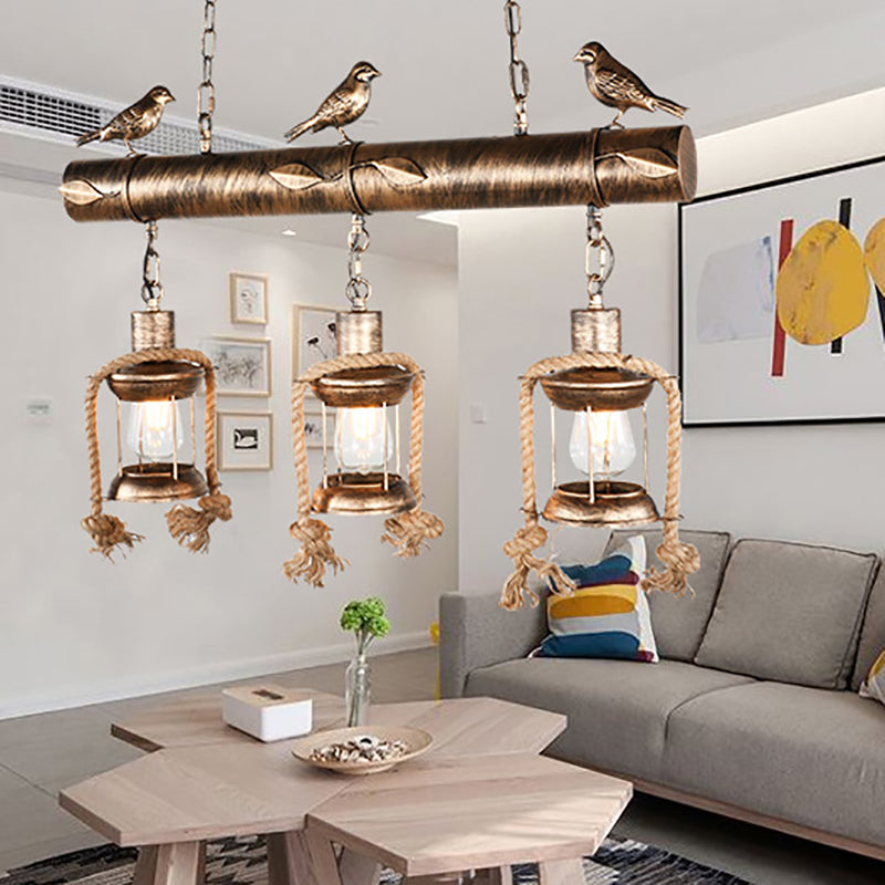 Coastal Lantern Island Pendant 3-Light Clear Glass Hanging Lamp Kit in Antique Brass with Bird Clearhalo 'Ceiling Lights' 'Island Lights' Lighting' 162845