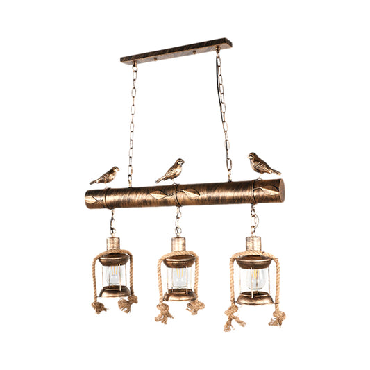 Coastal Lantern Island Pendant 3-Light Clear Glass Hanging Lamp Kit in Antique Brass with Bird Clearhalo 'Ceiling Lights' 'Island Lights' Lighting' 162846