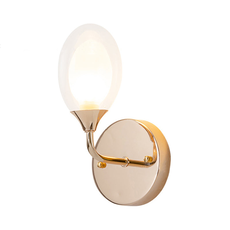 Modern Oval Shade Wall Lighting 1 Bulb Clear Glass Sconce Light in Brass for Dining Room Clearhalo 'Cast Iron' 'Glass' 'Industrial' 'Modern wall lights' 'Modern' 'Tiffany' 'Traditional wall lights' 'Wall Lamps & Sconces' 'Wall Lights' Lighting' 165901