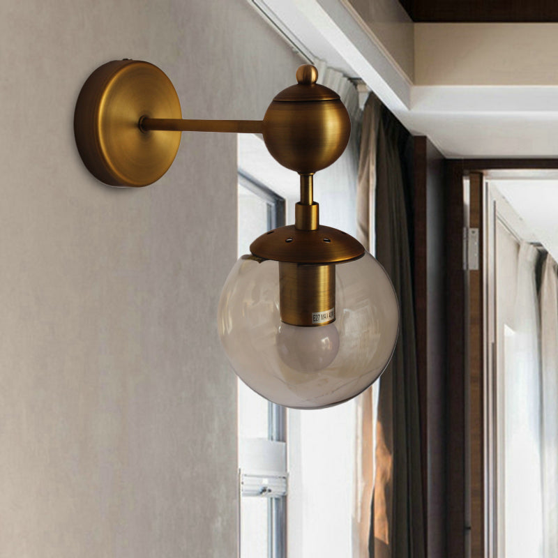 Globe Shaped Wall Sconce Post Modern Amber Glass 1/2 Light Brass Wall Mount Lighting 1.0 Brass Clearhalo 'Cast Iron' 'Glass' 'Industrial' 'Modern wall lights' 'Modern' 'Tiffany' 'Traditional wall lights' 'Wall Lamps & Sconces' 'Wall Lights' Lighting' 186754