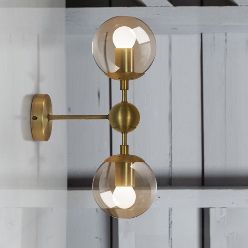 Globe Shaped Wall Sconce Post Modern Amber Glass 1/2 Light Brass Wall Mount Lighting 2.0 Brass Clearhalo 'Cast Iron' 'Glass' 'Industrial' 'Modern wall lights' 'Modern' 'Tiffany' 'Traditional wall lights' 'Wall Lamps & Sconces' 'Wall Lights' Lighting' 186758