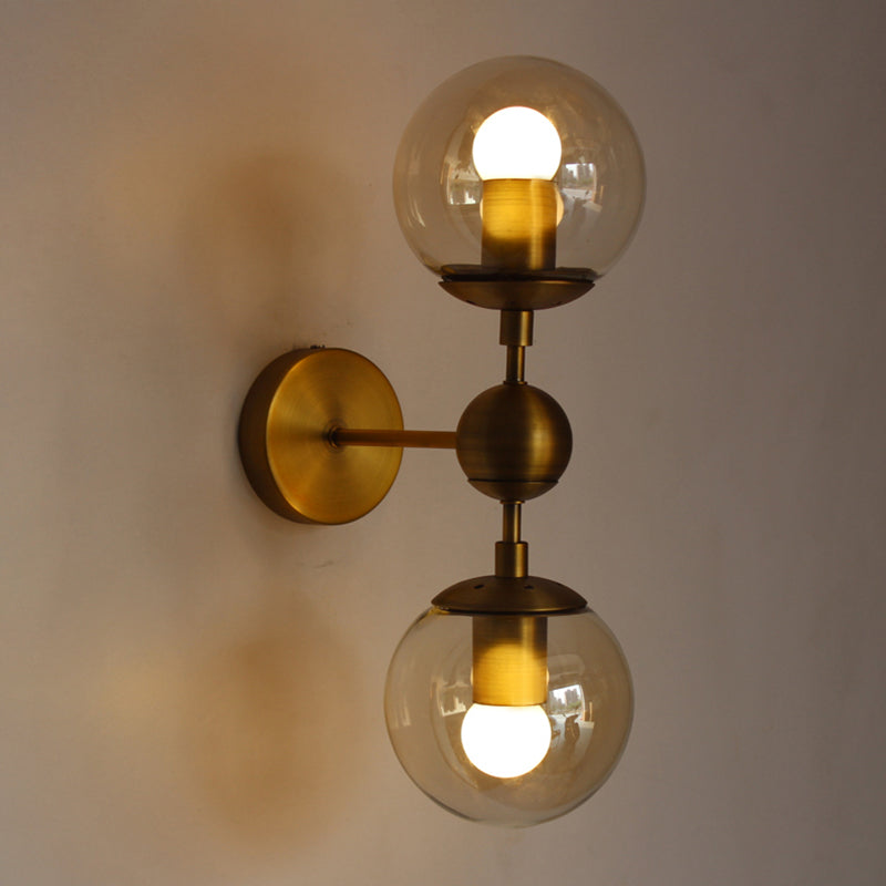 Globe Shaped Wall Sconce Post Modern Amber Glass 1/2 Light Brass Wall Mount Lighting Clearhalo 'Cast Iron' 'Glass' 'Industrial' 'Modern wall lights' 'Modern' 'Tiffany' 'Traditional wall lights' 'Wall Lamps & Sconces' 'Wall Lights' Lighting' 186759