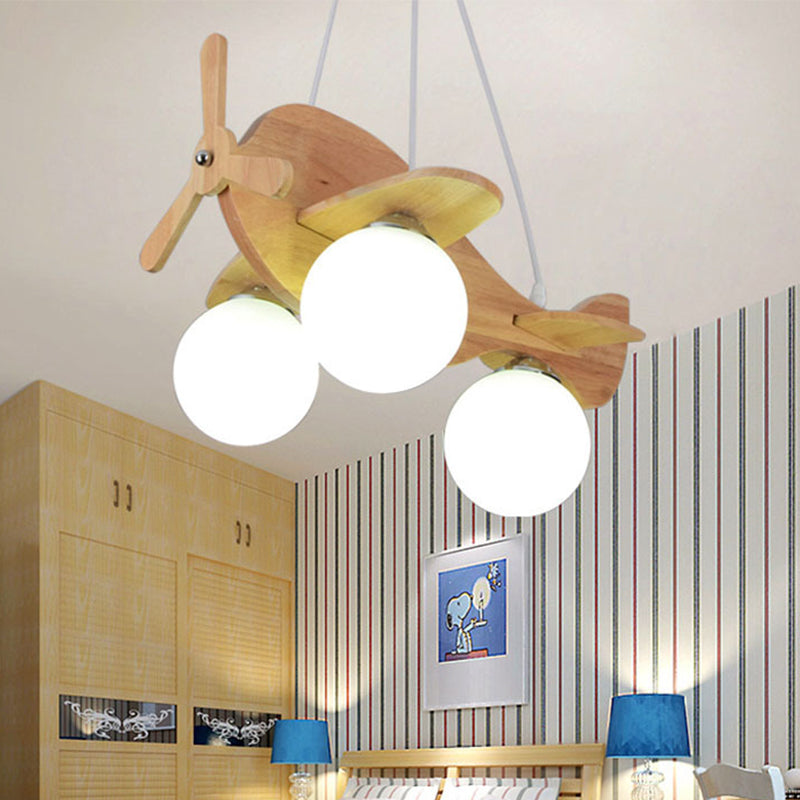 Creative Kids 3-Light Hanging Lamp Wood Plane Shaped Chandelier with Ball White Glass Shade Clearhalo 'Ceiling Lights' 'Chandeliers' Lighting' options 1909467