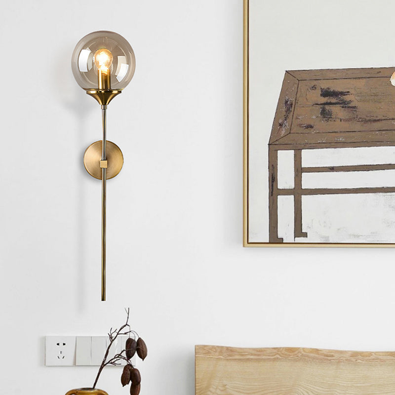 Ball Shade Pencil-Arm Wall Lighting Postmodern Clear/Amber/Smoke Grey Glass Single Brass Wall Mounted Lamp Clearhalo 'Cast Iron' 'Glass' 'Industrial' 'Modern wall lights' 'Modern' 'Tiffany' 'Traditional wall lights' 'Wall Lamps & Sconces' 'Wall Lights' Lighting' 1936533