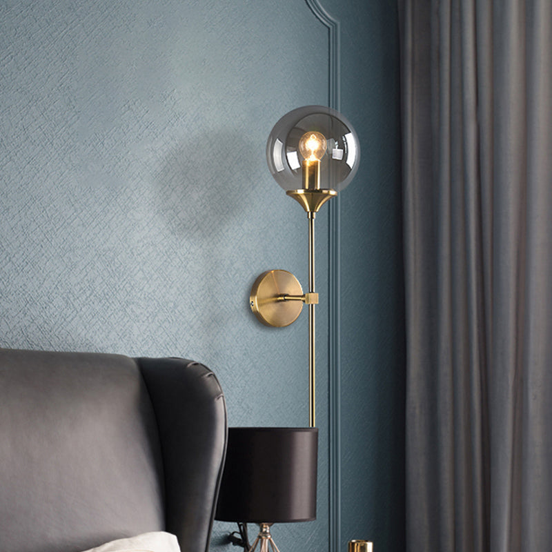 Ball Shade Pencil-Arm Wall Lighting Postmodern Clear/Amber/Smoke Grey Glass Single Brass Wall Mounted Lamp Smoke Gray Clearhalo 'Cast Iron' 'Glass' 'Industrial' 'Modern wall lights' 'Modern' 'Tiffany' 'Traditional wall lights' 'Wall Lamps & Sconces' 'Wall Lights' Lighting' 1936537