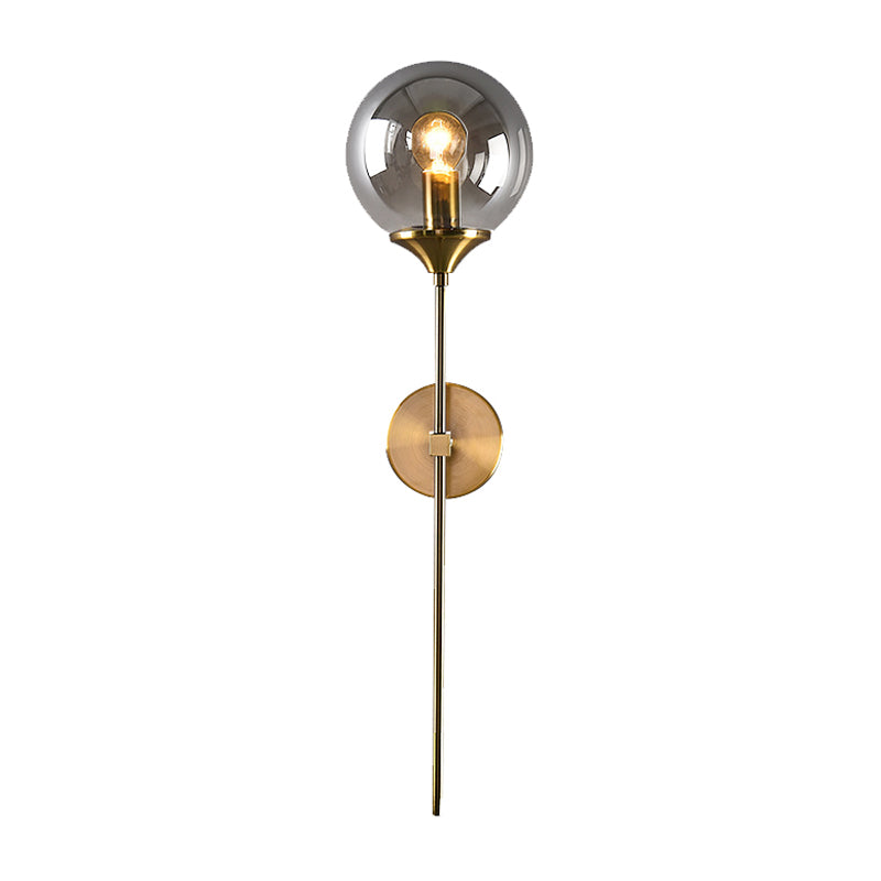 Ball Shade Pencil-Arm Wall Lighting Postmodern Clear/Amber/Smoke Grey Glass Single Brass Wall Mounted Lamp Clearhalo 'Cast Iron' 'Glass' 'Industrial' 'Modern wall lights' 'Modern' 'Tiffany' 'Traditional wall lights' 'Wall Lamps & Sconces' 'Wall Lights' Lighting' 1936539