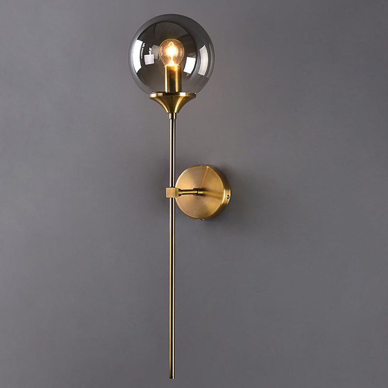 Ball Shade Pencil-Arm Wall Lighting Postmodern Clear/Amber/Smoke Grey Glass Single Brass Wall Mounted Lamp Clearhalo 'Cast Iron' 'Glass' 'Industrial' 'Modern wall lights' 'Modern' 'Tiffany' 'Traditional wall lights' 'Wall Lamps & Sconces' 'Wall Lights' Lighting' 1936540