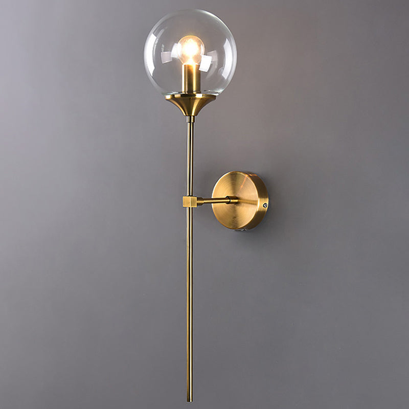 Ball Shade Pencil-Arm Wall Lighting Postmodern Clear/Amber/Smoke Grey Glass Single Brass Wall Mounted Lamp Clearhalo 'Cast Iron' 'Glass' 'Industrial' 'Modern wall lights' 'Modern' 'Tiffany' 'Traditional wall lights' 'Wall Lamps & Sconces' 'Wall Lights' Lighting' 1936544