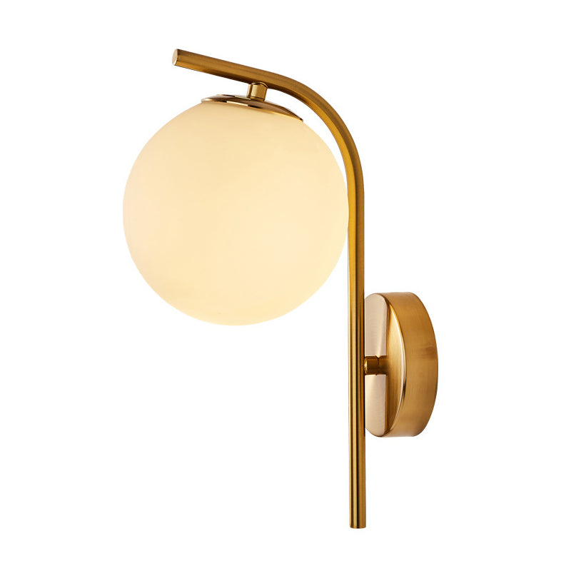 Postmodern Ball Wall Mount Light Grey/Clear Water/White Glass Single-Bulb Bedside Wall Lamp with Bent Arm in Brass Clearhalo 'Cast Iron' 'Glass' 'Industrial' 'Modern wall lights' 'Modern' 'Tiffany' 'Traditional wall lights' 'Wall Lamps & Sconces' 'Wall Lights' Lighting' 1936622