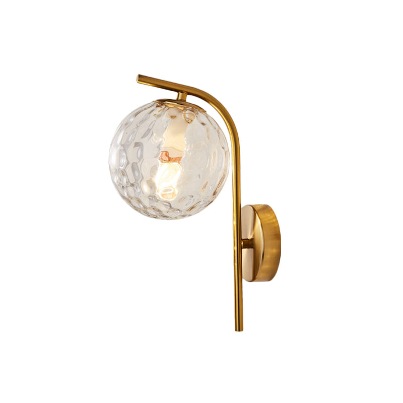 Postmodern Ball Wall Mount Light Grey/Clear Water/White Glass Single-Bulb Bedside Wall Lamp with Bent Arm in Brass Clearhalo 'Cast Iron' 'Glass' 'Industrial' 'Modern wall lights' 'Modern' 'Tiffany' 'Traditional wall lights' 'Wall Lamps & Sconces' 'Wall Lights' Lighting' 1936624