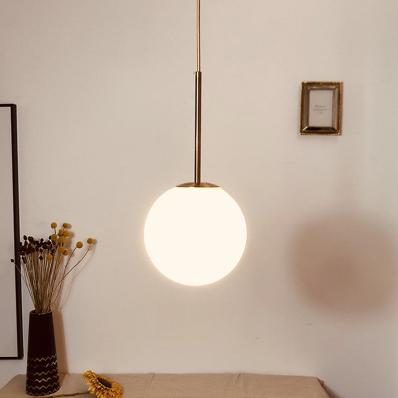 Simple Ball Shaped Drop Pendant White Glass 1 Light 6"/8"/10" Dia Bedroom Pendulum Light in Brass White Clearhalo 'Ceiling Lights' 'Modern Pendants' 'Modern' 'Pendant Lights' 'Pendants' Lighting' 1936786