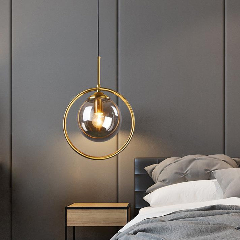 Globe Down Lighting Pendant Postmodern Clear/Amber/Smoke Grey Glass Single-Bulb Bedroom Suspension Light with Brass Ring Smoke Gray Clearhalo 'Ceiling Lights' 'Glass shade' 'Glass' 'Modern Pendants' 'Modern' 'Pendant Lights' 'Pendants' Lighting' 1937397