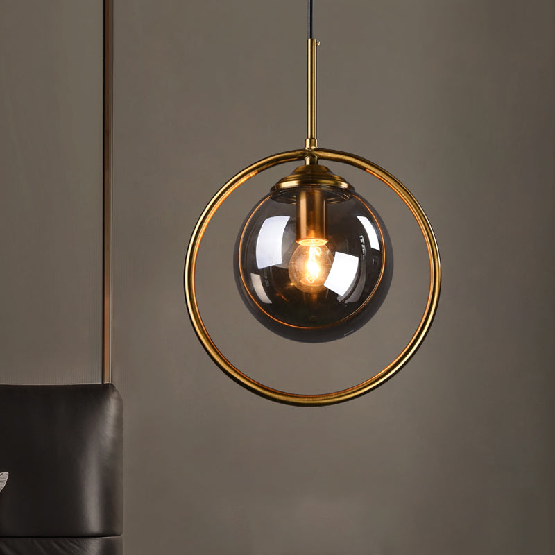Globe Down Lighting Pendant Postmodern Clear/Amber/Smoke Grey Glass Single-Bulb Bedroom Suspension Light with Brass Ring Clearhalo 'Ceiling Lights' 'Glass shade' 'Glass' 'Modern Pendants' 'Modern' 'Pendant Lights' 'Pendants' Lighting' 1937398
