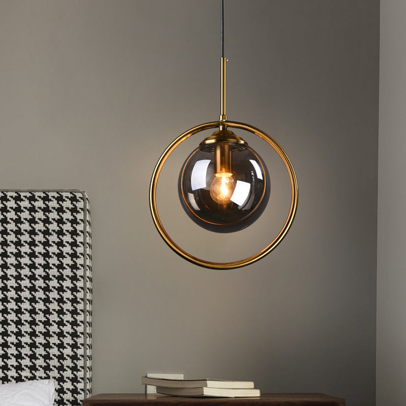 Globe Down Lighting Pendant Postmodern Clear/Amber/Smoke Grey Glass Single-Bulb Bedroom Suspension Light with Brass Ring Clearhalo 'Ceiling Lights' 'Glass shade' 'Glass' 'Modern Pendants' 'Modern' 'Pendant Lights' 'Pendants' Lighting' 1937399