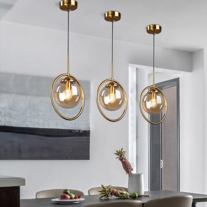 Globe Down Lighting Pendant Postmodern Clear/Amber/Smoke Grey Glass Single-Bulb Bedroom Suspension Light with Brass Ring Clearhalo 'Ceiling Lights' 'Glass shade' 'Glass' 'Modern Pendants' 'Modern' 'Pendant Lights' 'Pendants' Lighting' 1937403