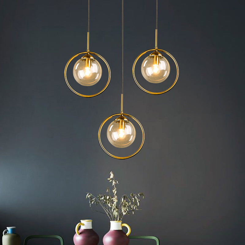 Globe Down Lighting Pendant Postmodern Clear/Amber/Smoke Grey Glass Single-Bulb Bedroom Suspension Light with Brass Ring Clearhalo 'Ceiling Lights' 'Glass shade' 'Glass' 'Modern Pendants' 'Modern' 'Pendant Lights' 'Pendants' Lighting' 1937404