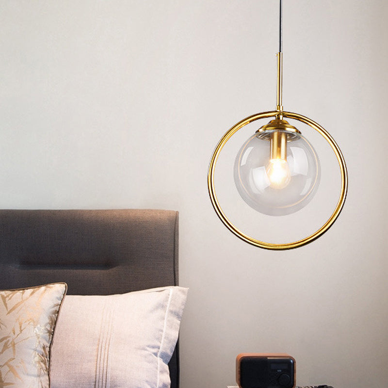 Globe Down Lighting Pendant Postmodern Clear/Amber/Smoke Grey Glass Single-Bulb Bedroom Suspension Light with Brass Ring Clear Clearhalo 'Ceiling Lights' 'Glass shade' 'Glass' 'Modern Pendants' 'Modern' 'Pendant Lights' 'Pendants' Lighting' 1937406