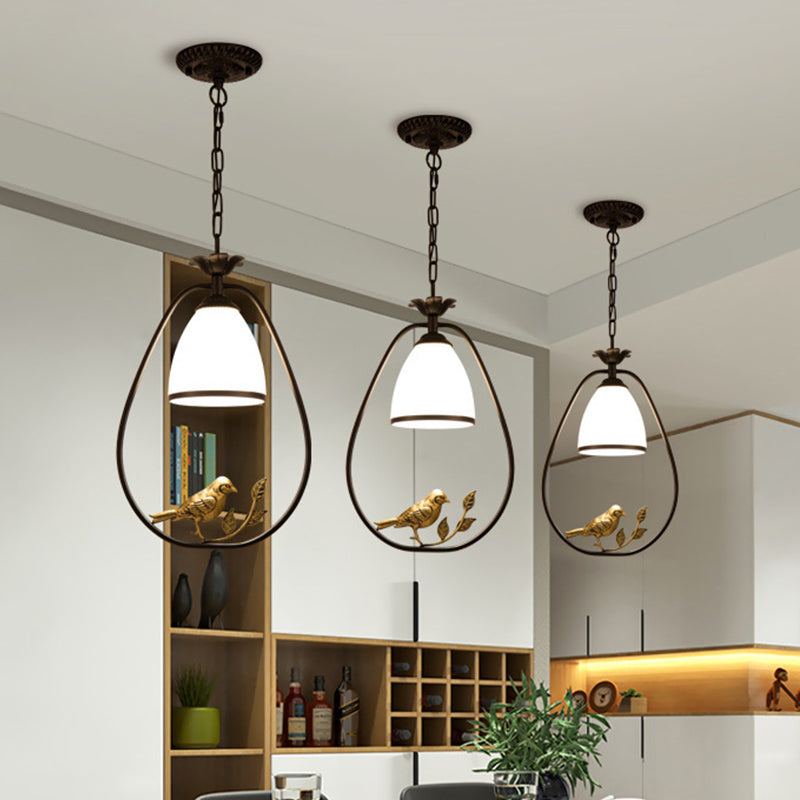 Rustic Oval/Round Pendulum Light 1 Bulb Metal Pendant Lamp in Black with Bell White Glass Shade and Bird Decoration Clearhalo 'Ceiling Lights' 'Pendant Lights' 'Pendants' Lighting' 1972261