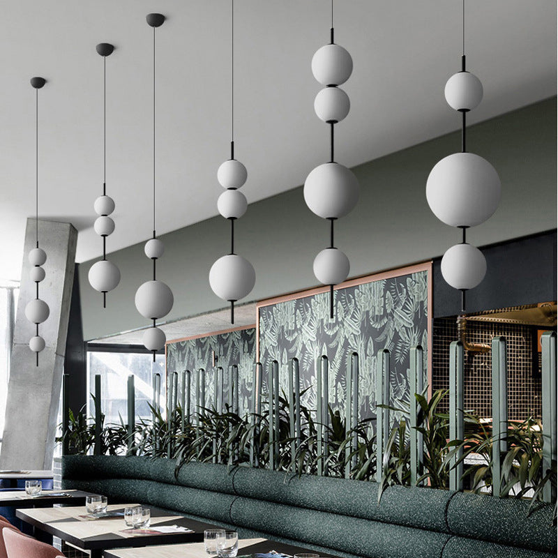 Ball Dining Room Pendulum Light Cream Glass LED Modernity Chandelier Lighting Fixture in Black Clearhalo 'Ceiling Lights' 'Chandeliers' 'Glass shade' 'Glass' 'Modern Chandeliers' 'Modern' Lighting' 2039426