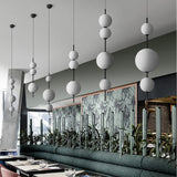Ball Dining Room Pendulum Light Cream Glass LED Modernity Chandelier Lighting Fixture in Black Clearhalo 'Ceiling Lights' 'Chandeliers' 'Glass shade' 'Glass' 'Modern Chandeliers' 'Modern' Lighting' 2039426