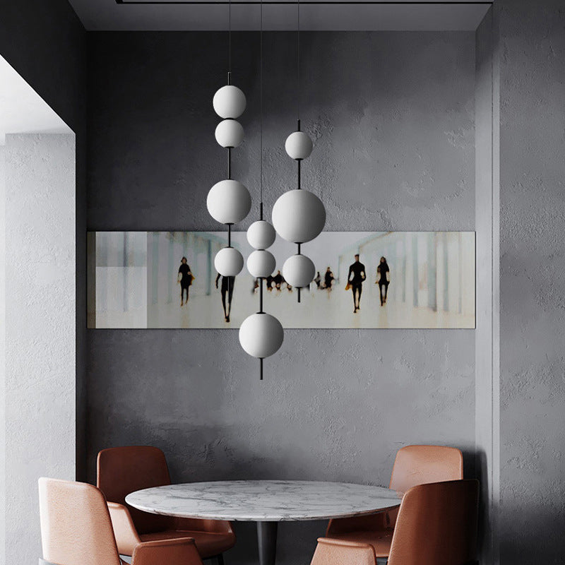Ball Dining Room Pendulum Light Cream Glass LED Modernity Chandelier Lighting Fixture in Black Clearhalo 'Ceiling Lights' 'Chandeliers' 'Glass shade' 'Glass' 'Modern Chandeliers' 'Modern' Lighting' 2039428