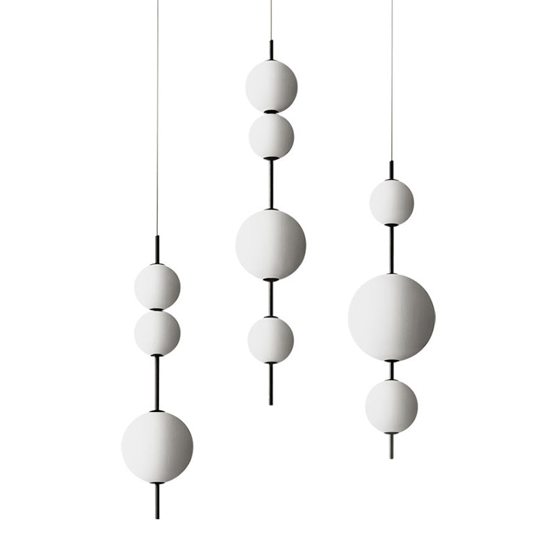 Ball Dining Room Pendulum Light Cream Glass LED Modernity Chandelier Lighting Fixture in Black Clearhalo 'Ceiling Lights' 'Chandeliers' 'Glass shade' 'Glass' 'Modern Chandeliers' 'Modern' Lighting' 2039429