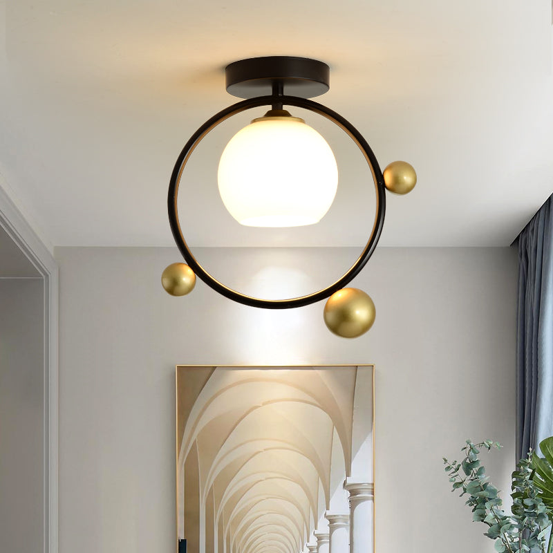 White Glass Sphere Semi Flush Mount Modernist 1 Light Black Semi Flush Mount Light Fixture with Iron Ring, 10"/12" Wide Black 12" Clearhalo 'Ceiling Lights' 'Close To Ceiling Lights' 'Close to ceiling' 'Glass shade' 'Glass' 'Semi-flushmount' Lighting' 212440