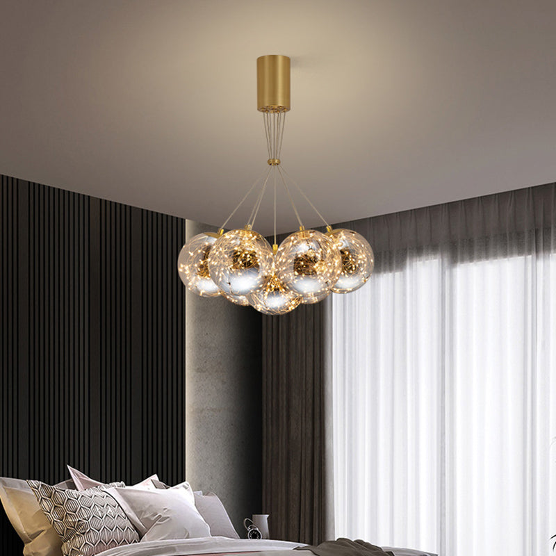 Sphere Handblown Glass LED Multi Light Pendant Modern Brass Starry Hanging Lighting 7 Brass Clearhalo 'Ceiling Lights' 'Modern Pendants' 'Modern' 'Pendant Lights' 'Pendants' Lighting' 2162529