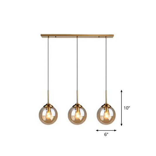 Minimalistic Spherical Multi Ceiling Light Glass 3-Bulb Dining Room Suspension Pendant in Brass Clearhalo 'Ceiling Lights' 'Modern Pendants' 'Modern' 'Pendant Lights' 'Pendants' Lighting' 2266042