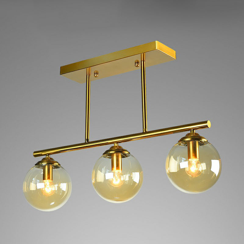 Brass Linear Island Light Fixture Postmodern Metal Ceiling Light with Globe Glass Shade 3 Amber Clearhalo 'Ceiling Lights' 'Island Lights' Lighting' 2354397