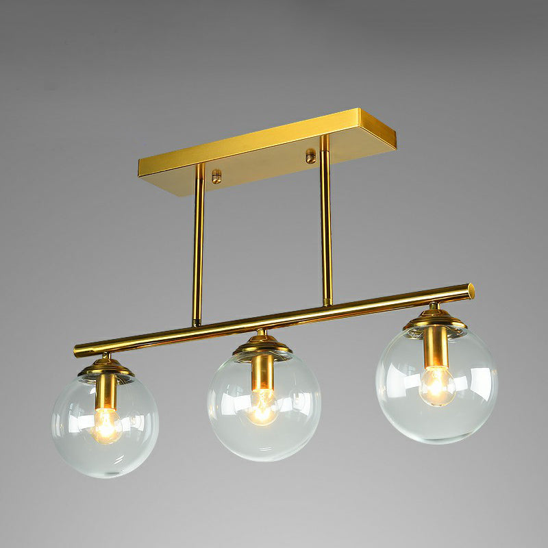 Brass Linear Island Light Fixture Postmodern Metal Ceiling Light with Globe Glass Shade 3 Clear Clearhalo 'Ceiling Lights' 'Island Lights' Lighting' 2354401