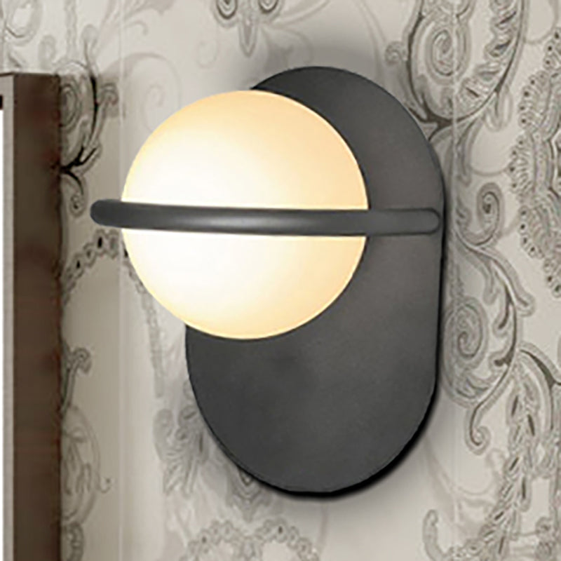 Modernist Orb Wall Light Milk Glass 1 Bulb Bedroom Sconce Lighting with Oval Metal Backplate in Black/Gold Black Clearhalo 'Cast Iron' 'Glass' 'Industrial' 'Modern wall lights' 'Modern' 'Tiffany' 'Traditional wall lights' 'Wall Lamps & Sconces' 'Wall Lights' Lighting' 236039