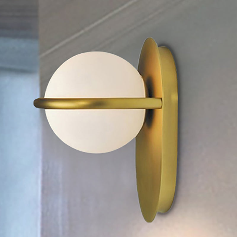 Modernist Orb Wall Light Milk Glass 1 Bulb Bedroom Sconce Lighting with Oval Metal Backplate in Black/Gold Gold Clearhalo 'Cast Iron' 'Glass' 'Industrial' 'Modern wall lights' 'Modern' 'Tiffany' 'Traditional wall lights' 'Wall Lamps & Sconces' 'Wall Lights' Lighting' 236041